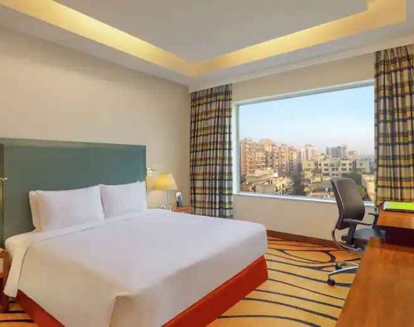 Bright hotel room with desk at the DoubleTree by Hilton Hotel Gurgaon - New Delhi NCR.