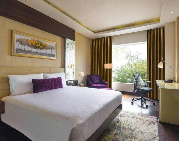 King bedroom with desk at the DoubleTree by Hilton Gurugram Baani Square.