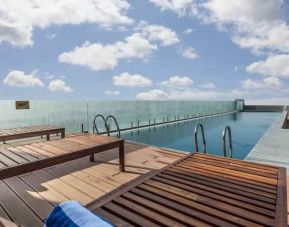 Outdoor pool area at the DoubleTree by Hilton Ahmedabad.