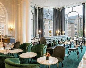 Seating area perfect as workspace at the Hilton Brussels Grand Place .