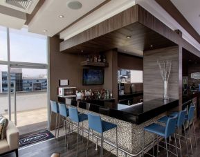 Seating area along the bar at the Hampton by Hilton Lima San Isidro.