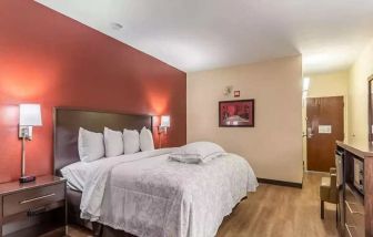 Spacious delux king bedroom at Red Roof PLUS+ & Suites Houston - IAH Airport SW.