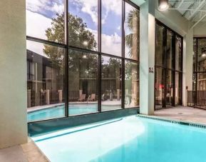 Combo indoor-outdoor pool with seating area at Red Roof PLUS+ & Suites Houston - IAH Airport SW.