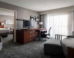 Luxurious king suite with lounge, TV, and work desk at Sonesta Select Phoenix Chandler.