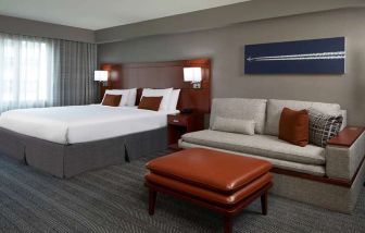 Guest room with sofa at Courtyard By Marriott Los Angeles LAX/Century Boulevard.