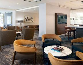 Seating area with TV screen at Courtyard By Marriott Los Angeles LAX/Century Boulevard.