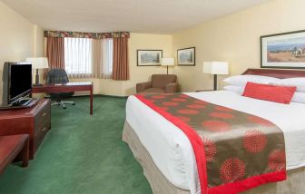 Hotel bedroom with workstation at Riviera Plaza And Conference Centre Calgary Airport.