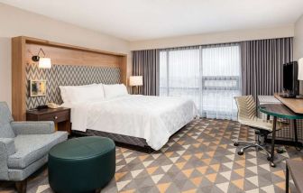 King bedroom with workstation at Holiday Inn Toronto Airport East.