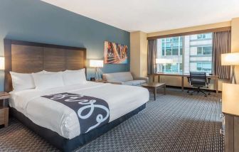 King bedroom with desk and sofa at La Quinta Inn & Suites By Wyndham Chicago Downtown.