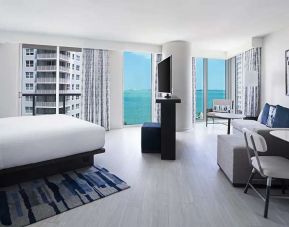 Hotel suite with TV screen, sofa and workstation at Hyatt Centric Brickell Miami.