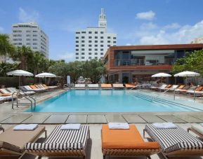 Outdoor pool with lounges at SLS South Beach.