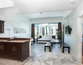 Living room with kitchenette and workspace at New Point Miami.