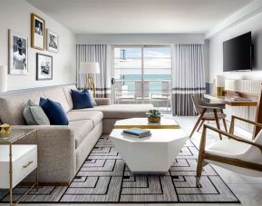 Living room with l shape sofa at Cadillac Hotel & Beach Club, Autograph Collection.