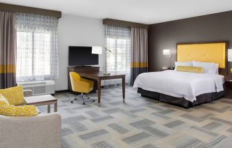 Spacious king bedroom with sofa at Hampton Inn & Suites Los Angeles/ Hollywood.