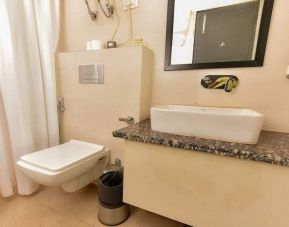 clean and spacious guest bathroom with shower at Hotel Luxury Stay.