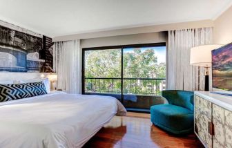 King bedroom with big window at Avenue Of The Arts Hotel.