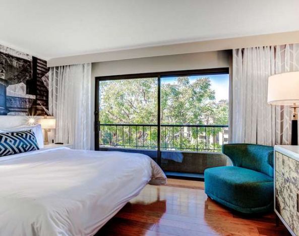 King bedroom with big window at Avenue Of The Arts Hotel.