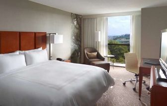 Bright king bedroom with window and workstation at Atlanta Marriott Northwest At Galleria.