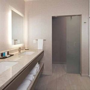 Guest bathroom with shower at H Hotel Los Angeles, Curio Collection By Hilton.
