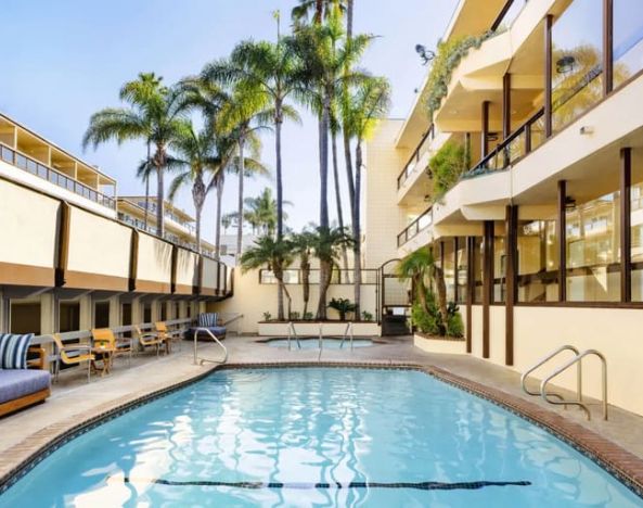 Lovely outdoor pool with seating area at Pacific Edge Hotel.