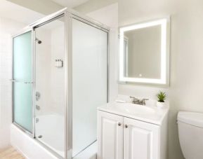 Clean and spacious guest bathroom with shower at Pacific Edge Hotel.