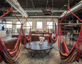 Comfortable lounge and coworking space with hammocks and couches at SCP Hotel Colorado Springs.