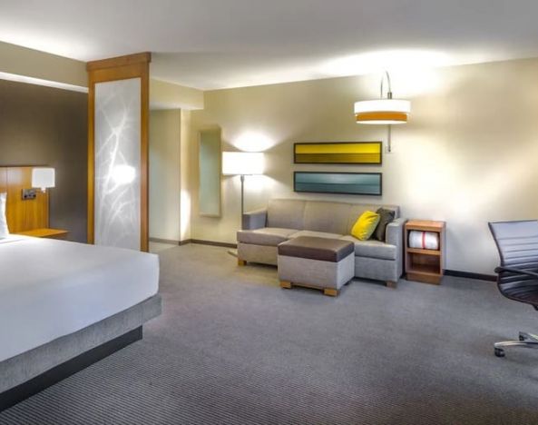 Spacious king suite with business desk and lounge area at Hyatt Place Washington D.C/National Mall.