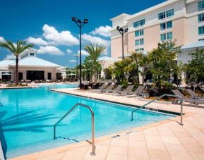 Stunning outdoor pool with sunbeds at TownePlace Suites Orlando at FLAMINGO CROSSINGS.