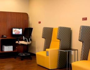 Equipped business center with PC, internet, printer, and work pods at TownePlace Suites Orlando at FLAMINGO CROSSINGS.