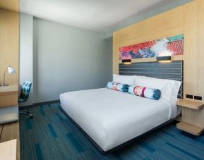 Comfortable king bedroom with business desk at Aloft Miami Aventura.