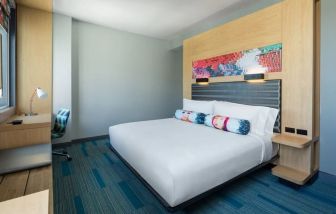 Comfortable king bedroom with business desk at Aloft Miami Aventura.