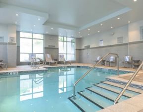 Lovely indoor pool with seating area at Courtyard Edgewater NYC.