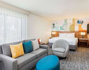 Spacious king suite with TV and lounge area at Clementine Hotel & Suites Anaheim.