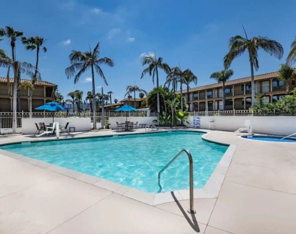 Stunning outdoor pool with seating area at Wyndham Garden San Diego near SeaWorld.