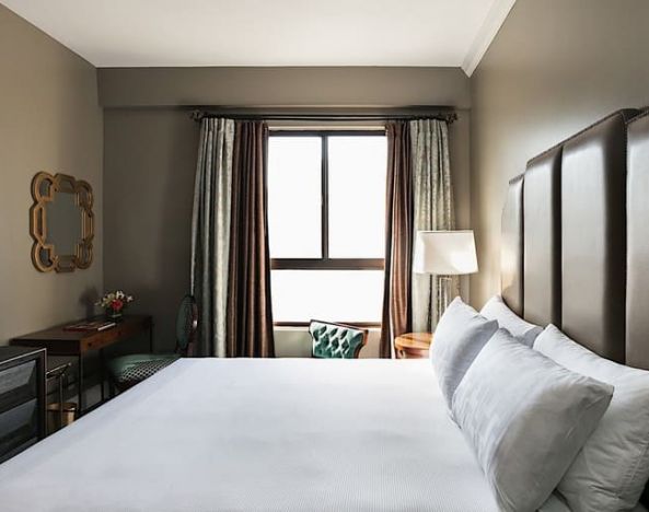 King bedroom with TV and business desk at Hotel Bijou.