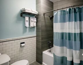 Private guest bathroom with shower and bath at Hotel Bijou.