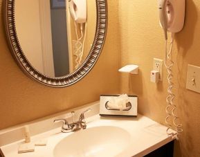 Private guest bathroom at Enclave Suites by Sky Hotels & Resorts.