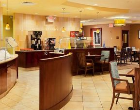 On-site dining at the Radisson Hotel JFK Airport, with hard floors and small tables.