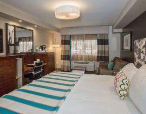 Comfortable delux king room with couch, business desk, and TV at The Kenilworth.