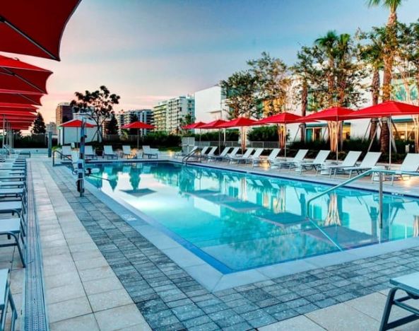 Stunning outdoor pool with sun beds at Residence Inn Miami Beach Surfside.