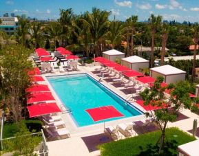 Large outdoor pool with umbrellas and sun beds at Residence Inn Miami Beach Surfside.