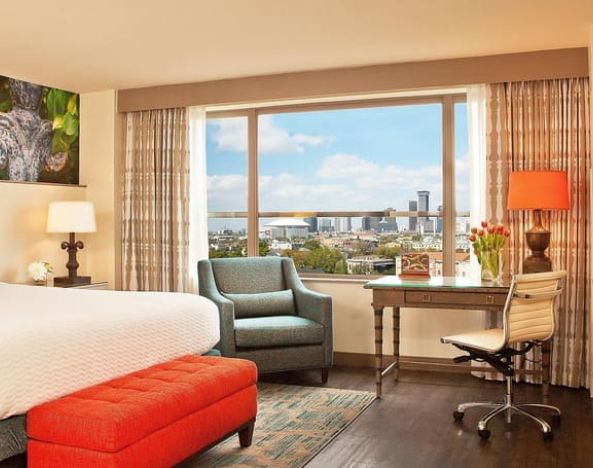 Comfortable king suite with business desk and TV at Hotel Indigo New Orleans Garden District.