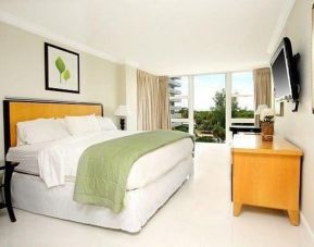 Comfortable king room with desk and TV at Ocean Manor Beach Resort.