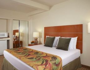 Relaxing king bedroom with mini-fridge and microwave at Waikiki Pearl.