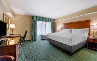 Spacious king room with TV and business desk at Holiday Inn Resort Lake Buena Vista.