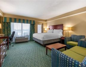 Luxurious king suite with TV, business desk, and lounge area at Holiday Inn Resort Lake Buena Vista.