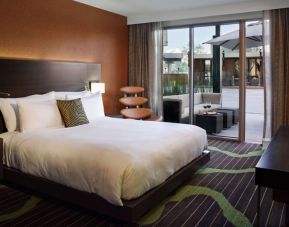 King bedroom with work space and balcony at Hard Rock Hotel San Diego.