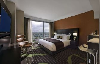 Spacious king suite with TV and business desk at Hard Rock Hotel San Diego.