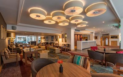 Multi-colored and eclectic chairs and tables fill a spacious lounge area.