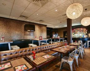 On-site dining at the Best Western Plus Newark Airport’s restaurant, which has small tables and a hard floor.